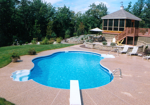 20' x 40' Oasis with exposed aggregate decking by Blue Dolphins Pools & Spas by Blue Dolphin Pools & Spas