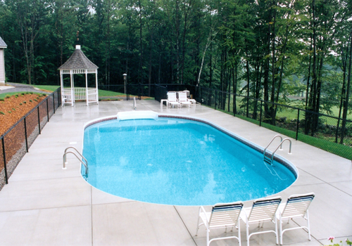 20' x 40' Custom oval with a broom finished deck by Blue Dolphin Pools & Spas